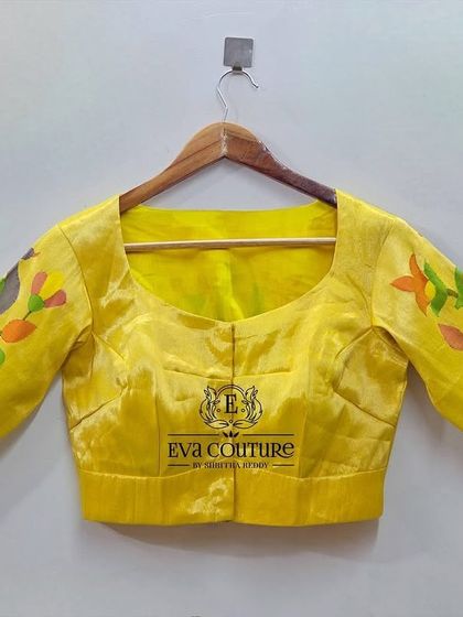A bright yellow pure handloom Paithani silk blouse. This front view shows the simple, elegant cut that highlights the woven sleeves.