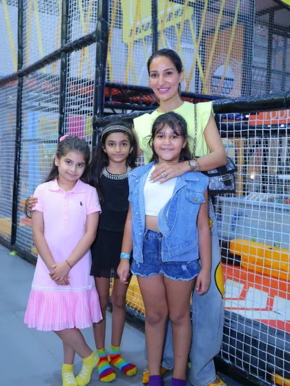 A guest with a group of young girls in the play area. It's a place where fun and friendship blossom.