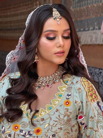 An eyes-closed shot to showcase the beautiful pink and brown eyeshadow, which complements her pastel outfit.