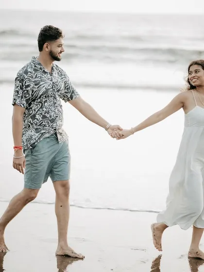 A happy, candid walk on the beach. This photo shows the couple's natural interaction and joy.