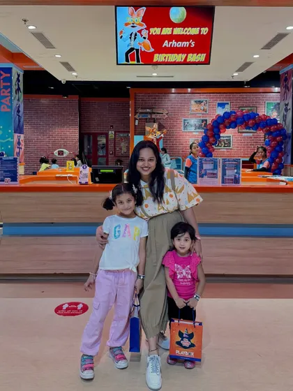 A family ready for a day of fun at our entrance. We welcome everyone for walk-in play and parties.