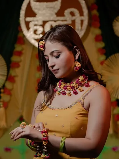 Another stunning shot of Nidhi, focusing on the details of her floral hand jewelry. These detail shots are a must-have for any Haldi album.