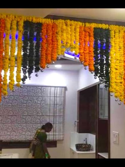 A housewarming decoration with hanging garlands of marigolds. This simple yet effective decoration brightens up the entrance to the home.