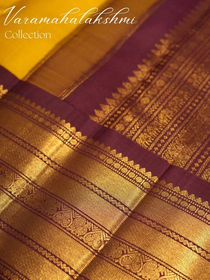 A close-up of the yellow and purple Kanjivaram, showcasing its rich border.