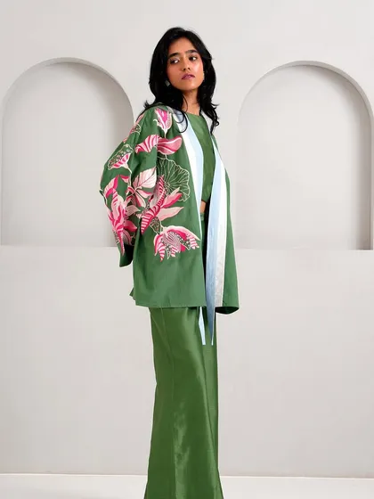 A full view of the green co-ord set from Madder Much, featuring a cropped jacket with floral embroidery and matching trousers.