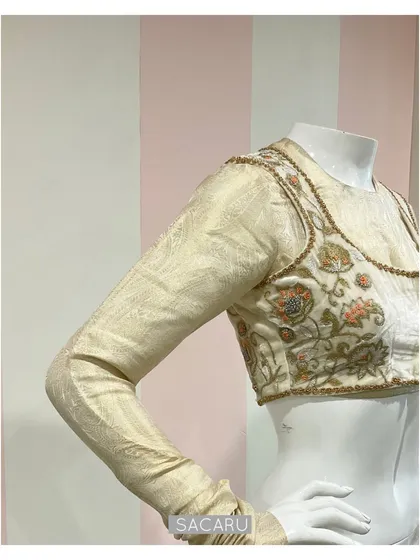 A studio shot of the double-layered saree blouse, with an inner silk jacquard full-sleeve blouse and an intricately embroidered velvet jacket.