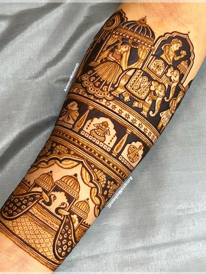 A detailed doli and baraat scene on the forearm. The design includes the bride in her palanquin, auspicious kalash symbols, and peacocks, all rendered with fine lines.