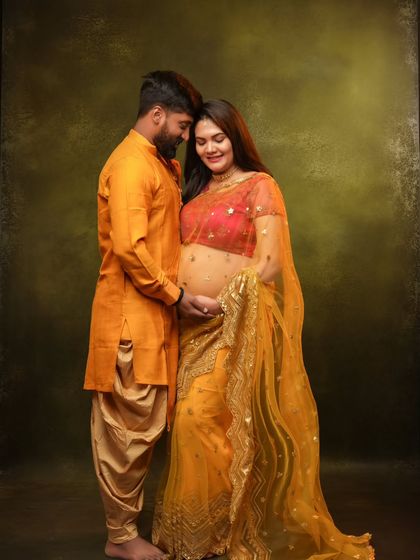 An intimate and loving pose, with the couple sharing a close moment, their outfits creating a warm and sunny color palette.