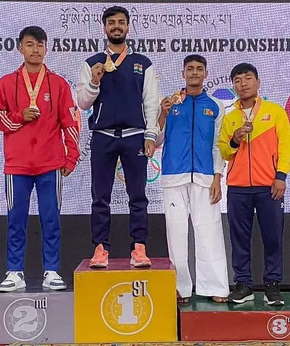 Tushar stands proudly at the top of the podium, gold medal secured, at the 8th South Asian Karate Championship in Bhutan.