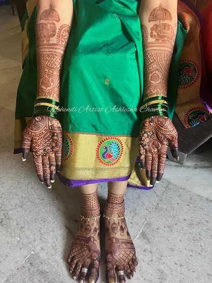 Stain goals. A full view of a bride's hands and feet, showcasing the beautiful, dark stain of her mehendi.