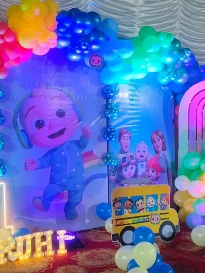 The full Cocomelon stage setup with party lighting.