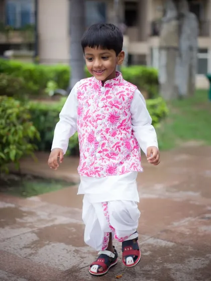 A duplicate of image 1, showing a happy boy walking in his birthday outfit. We capture kids in motion to get genuine smiles.