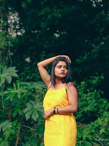 Using the dense foliage as a dark, moody background to make the subject in her yellow dress stand out.