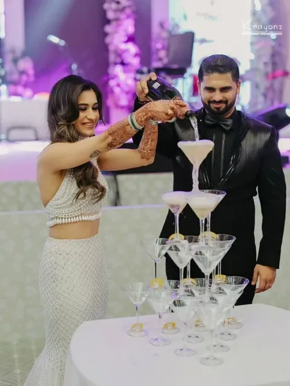 The classic champagne tower moment. A fun and celebratory tradition that adds a touch of glamour to the reception party.