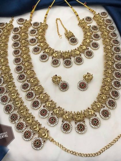 A South Indian style temple jewellery set with intricate carvings and studded stones.