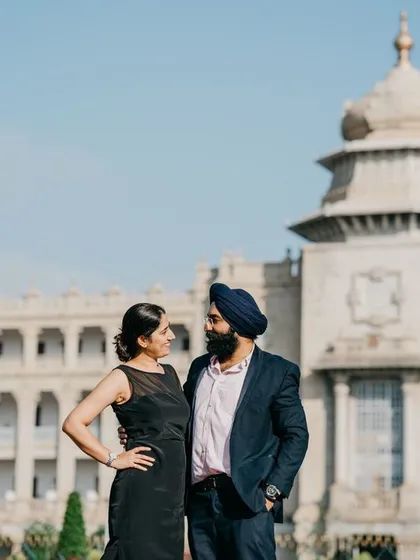 A posed shot of a couple in front of a government building in Bangalore, showcasing a formal urban pre-wedding style.