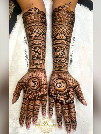A classic engagement mehndi design. I incorporated the couple's initials and interlocking rings into a beautiful floral pattern, making it a perfect symbol of their union.
