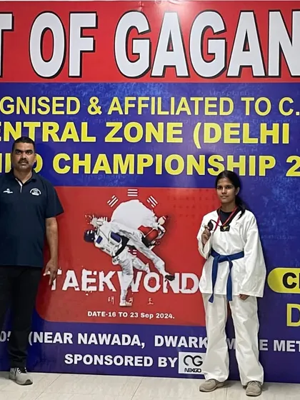 Standing with our bronze medalist, Anushka Sharma. My role as a coach is to be there to celebrate these moments of achievement with my students.