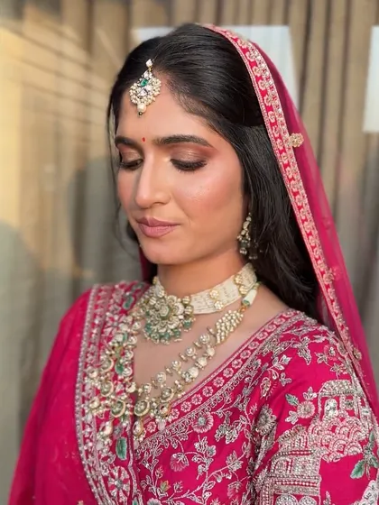 A detailed look at the eye makeup, featuring a blend of bronze and gold shadows that make her eyes pop.