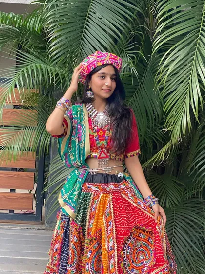 A confident pose with a pagdi, adding a touch of unique style to this traditional chaniya choli.