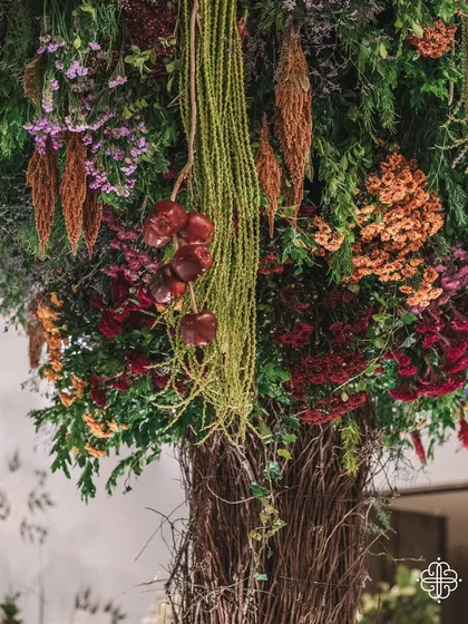 A close-up of the 'Orchard of Life' decor, with fruits and flowers hanging from the handcrafted trees.