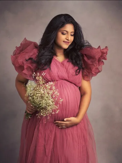 I believe every mother-to-be should feel like a queen. This portrait showcases one of the beautiful, bold ruffled gowns from my collection, creating a look that is both fashionable and deeply expressive of the beauty of pregnancy.