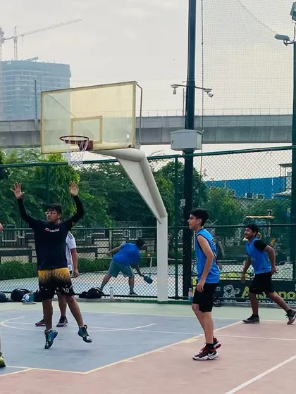 A player sets up for a shot while teammates get into rebounding position. This shows the teamwork and awareness we instill.