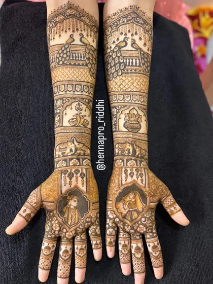 I adore creating full bridal arms with traditional Indian motifs. This design features majestic peacocks, auspicious wedding symbols like the kalash, and portraits of the bride and groom for a classic look.