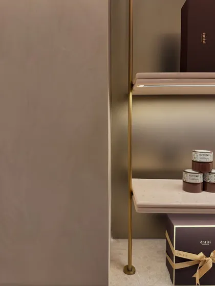 This detail shot of the shelving at Entisi highlights the clean joinery between the brass supports and the marble shelves. Such subtle details are what contribute to the overall feeling of refined minimalism in the space.