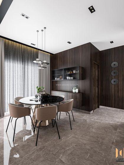 The dining area is defined by its fluted wall panels and modern chandelier, creating an intimate and stylish atmosphere.