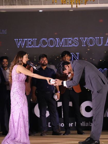 Handing out an award at the CINDA annual day. I handle awards ceremonies with grace and enthusiasm, making each winner feel special.