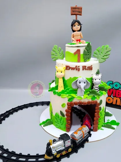 A three-tier Jungle Book cake with a toy train running through a tunnel at the base. This interactive cake was a huge hit at the party.