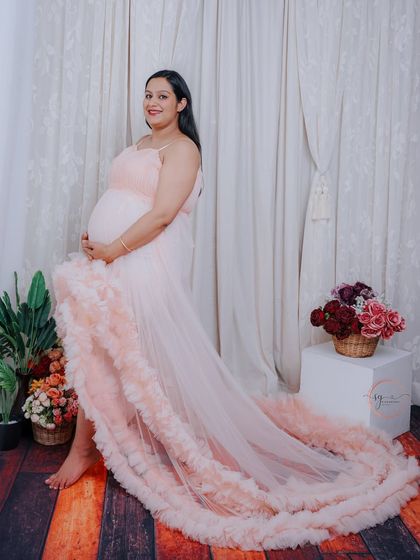 A graceful side-profile portrait. The long train of the ruffled gown creates a beautiful line, adding elegance to the shot.