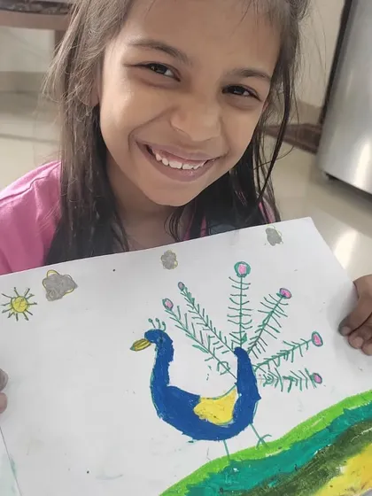 Eva proudly shows off her colorful peacock drawing. This piece represents a milestone in her journey, showcasing her improved focus and newfound confidence in expressing her own ideas.