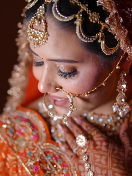 A delicate close-up portrait of the bride, focusing on her gentle expression and stunning matha patti.