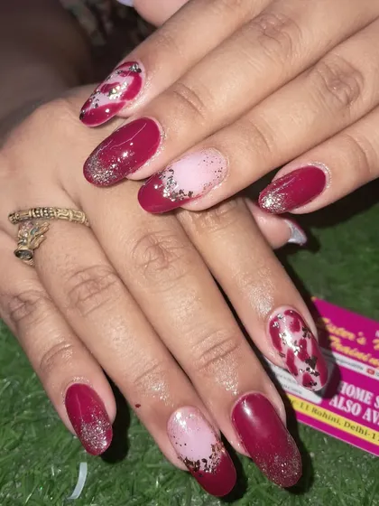 Another angle of this intricate red, pink, and silver foil nail design.