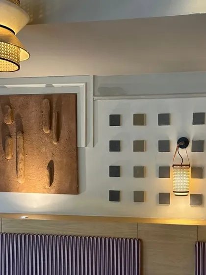 A textured artwork installation at Sidewalk, Agra. This project involved creating multiple pieces that worked together, including this earthy, sculptural panel.