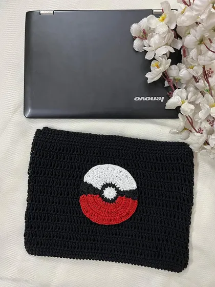This image shows the Pokémon laptop sleeve from a slightly different angle, emphasizing its soft, handmade texture.