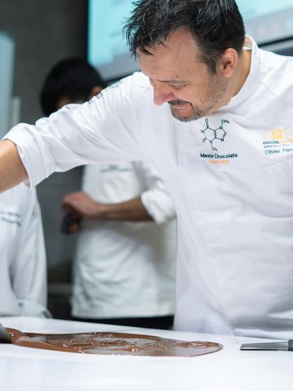 A master chocolatier demonstrates the tabling method of tempering chocolate, a fundamental skill for any aspiring pastry chef.