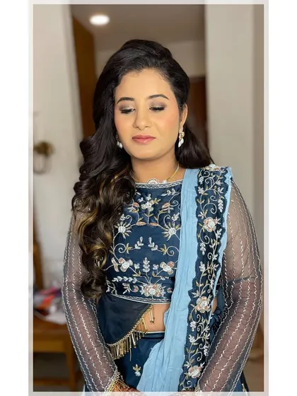Glowing skin is always the goal. For her Sangeet night, I created a radiant base with soft, shimmery eye makeup that complemented her beautiful blue and silver embroidered lehenga.
