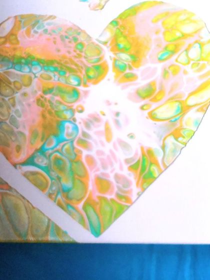 A close-up detail of a heart-shaped fluid art piece. The intricate cells and color blending show the delicate and surprising nature of this technique.