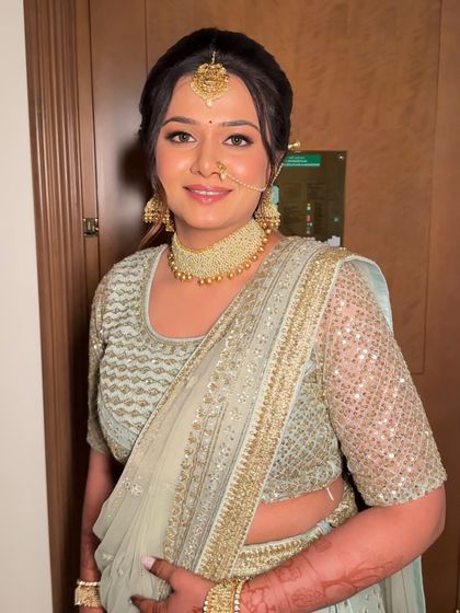 The bride's happy smile says it all. The makeup is fresh and radiant, enhancing her natural beauty and making her feel confident on her special day.