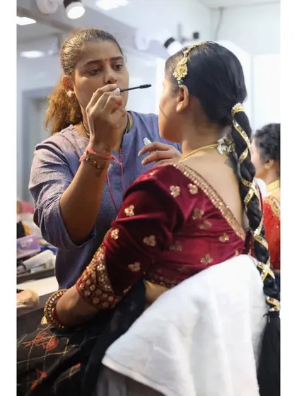 Here, a student is practicing mascara application on a model for a traditional look. We ensure they get comfortable working on real clients.