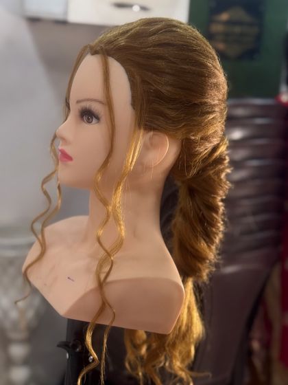 A modern, textured ponytail with soft curls. This versatile hairstyle is perfect for receptions or parties, and we cover how to create volume and texture in my course.