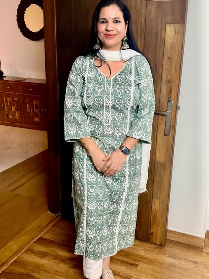 This green and white printed kurta was stitched from fabric and features delicate white lace detailing along the front panel and sleeves, adding a touch of elegance.