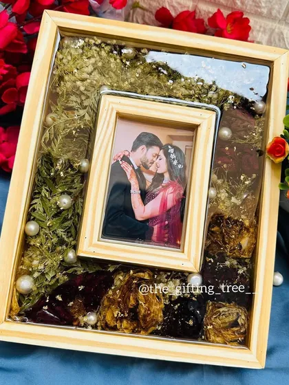 An 8x10 inch pinewood frame with a natural, light wood finish. Inside, we preserved an engagement bouquet with baby's breath and roses.