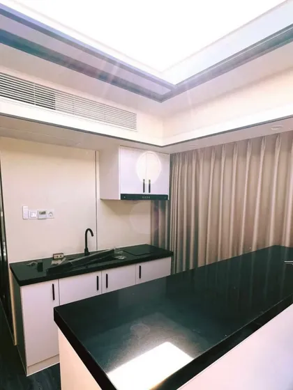 The sleek, modern kitchenette of the Space Capsule E8, featuring black countertops and minimalist white cabinets. Every detail is designed for a premium feel.