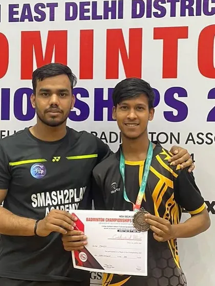 One of my students proudly displays his medal and certificate from the Delhi District Badminton Championship. I guide my players to compete and excel in local and regional tournaments.