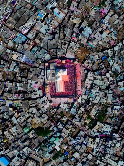The radial pattern of the streets of Nandgaon, with the temple at its heart, completely covered in the colors of Holi.