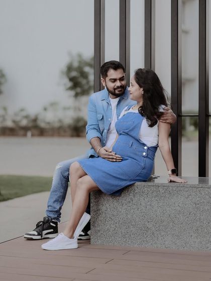The couple seated together, sharing a quiet moment. This photo captures the peaceful connection between them as they await their new baby.